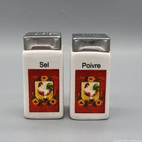 Front view showing French labels, rooster floral design, metal tops