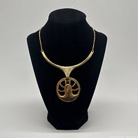 Full front view of necklace on display bust showing bar collar and pendant