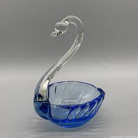 Angled view showing swan neck, blue bowl, color contrast