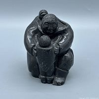 Front view of soapstone family sculpture
