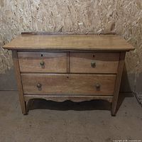 Front view of dresser showing overall form, drawers, knobs, finish