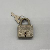 Front view of padlock with keys attached showing logo and keyway