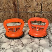 Front view of both orange suction cup lifters