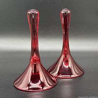 pair of cranberry red blown glass smoke bells front view