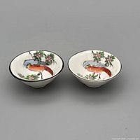 Pair of porcelain bowls showing bird motif inside each bowl