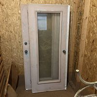 Two doors leaned against wall showing overall design and condition