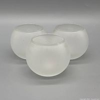 Three frosted glass votive holders front view