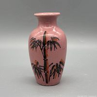 Front view of pink porcelain vase showing bamboo painting
