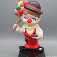 Full view of clown figurine with balloons and tray
