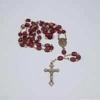 Entire rosary coiled showing beads, crucifix, centerpiece