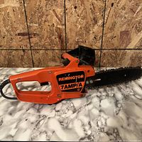 Full view of Remington 7AMP/A chainsaw showing cord and bar