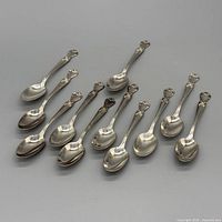 Full view of 10 silver-plated teaspoons laid out