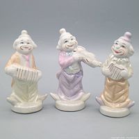Group view of all three pastel porcelain clown musician figurines