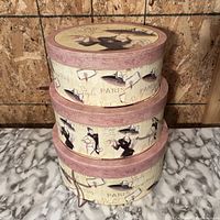 Stack of all three hat boxes showing size gradient and exterior graphics