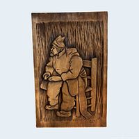Full view of carved wood plaque showing entire design