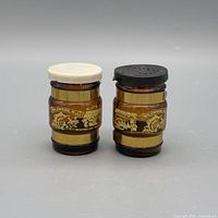 Front view of both amber glass shakers showing Wildwood NJ graphics, plastic tops and metal bands