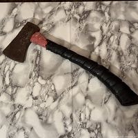 Full view of hatchet showing head, handle and tape grip
