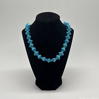 full view of turquoise geometric bead necklace displayed on bust