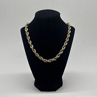 Full view of two-tone rope chain necklace on display bust