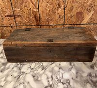 closed wooden toolbox front and top view