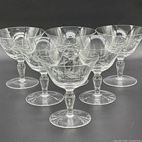 Six etched glass champagne coupes grouped