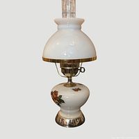 Full view of lamp showing milk glass shade, brass components and chimney