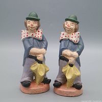 Full view of both clown figurines side by side