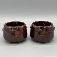 Front view of both West Bend glazed ceramic pots