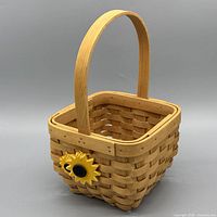 Angle view showing basket weave, handle and sunflower accent