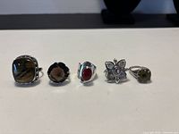 Front view of all five rings showing gemstone types and settings