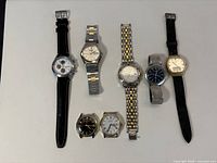 Seven Bulova Accutron watches laid out showing variety of straps and cases