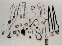Whole lot laid out showing necklaces, bracelets, earrings, pendants