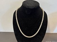 Chain displayed on bust form showing full length and rope style