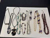 All jewelry pieces laid out on white board showing variety