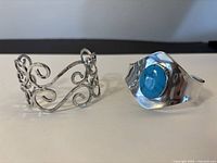 Both sterling silver cuff bracelets side by side