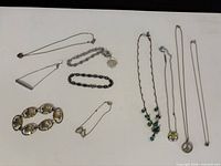 All ten jewellery pieces arranged on surface