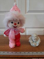 Both clown items with measuring ruler for scale