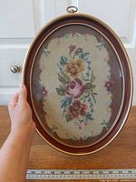 Front view showing entire framed needlepoint with ruler for scale