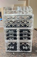Front view of clear acrylic organizer showing all drawers and top compartments