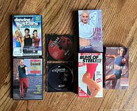 Group shot of all eight workout titles laid out on wooden floor