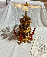 Full view of wooden carousel with candles and instruction sheet