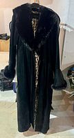 Full view of black suede maxi coat with faux fur collar and cuffs