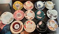 Group shot of all 12 teacup and saucer pairs