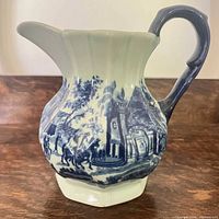 Right-side view of blue and white ironstone pitcher showing scenic transferware and handle