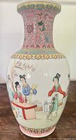 Overall view of Famille Rose porcelain vase showing figure scene and decorative neck