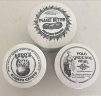 Top view of three lidded jars showing vintage label designs