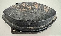 Top view of cast iron sad iron showing heavy rust