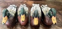 Front view of four wooden duck napkin holders