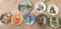 Group shot of 8 visible plates showing artwork designs