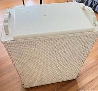 Front and top view of white wicker hamper showing lid and handle